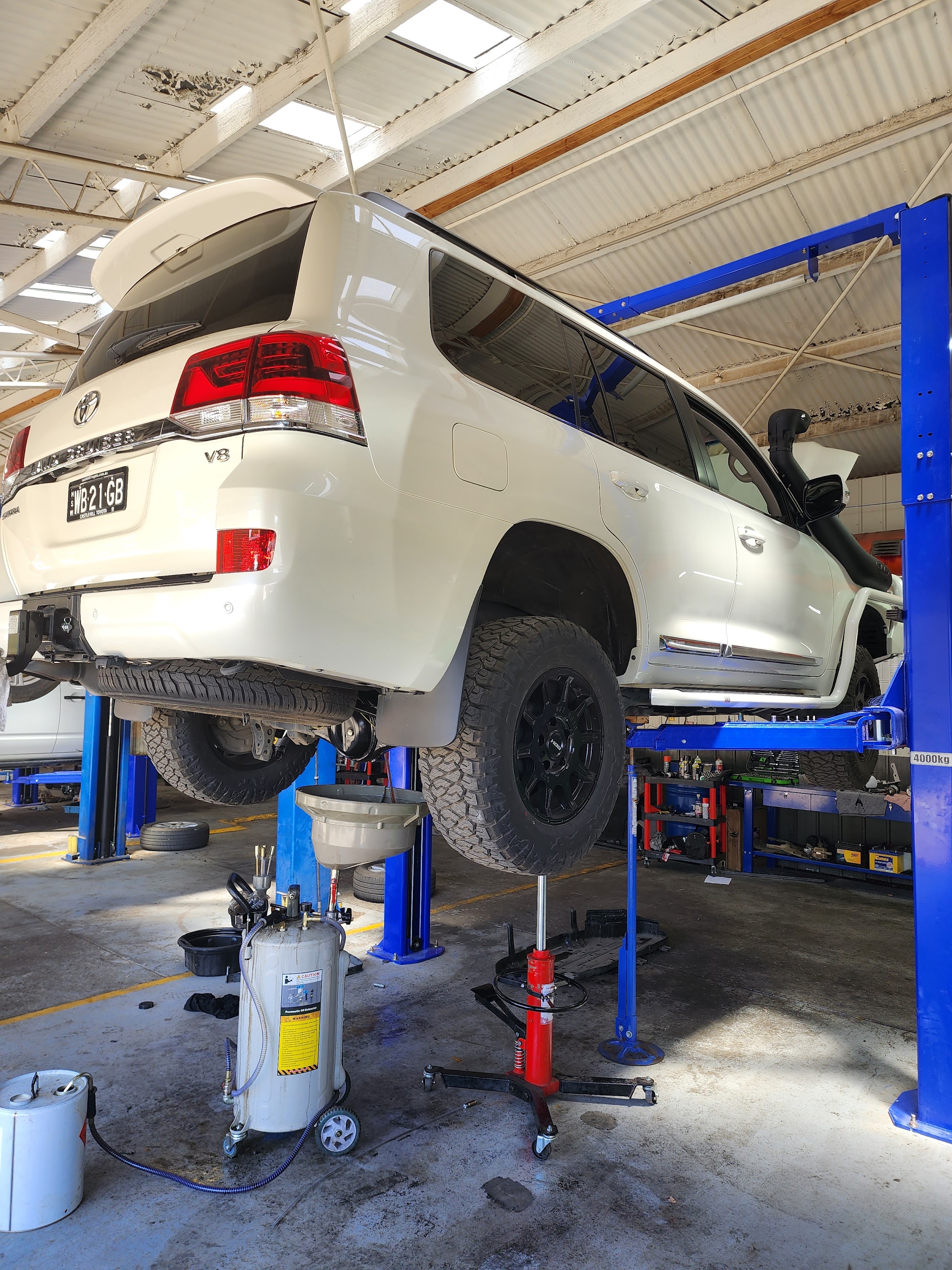 A Toyota Land Cruiser up on the hoist at Street Class Automotive in Benalla