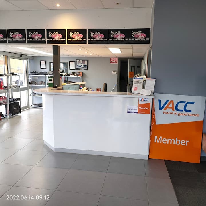 The front counter with the VACC member sign and Gulf Western Oil banners
